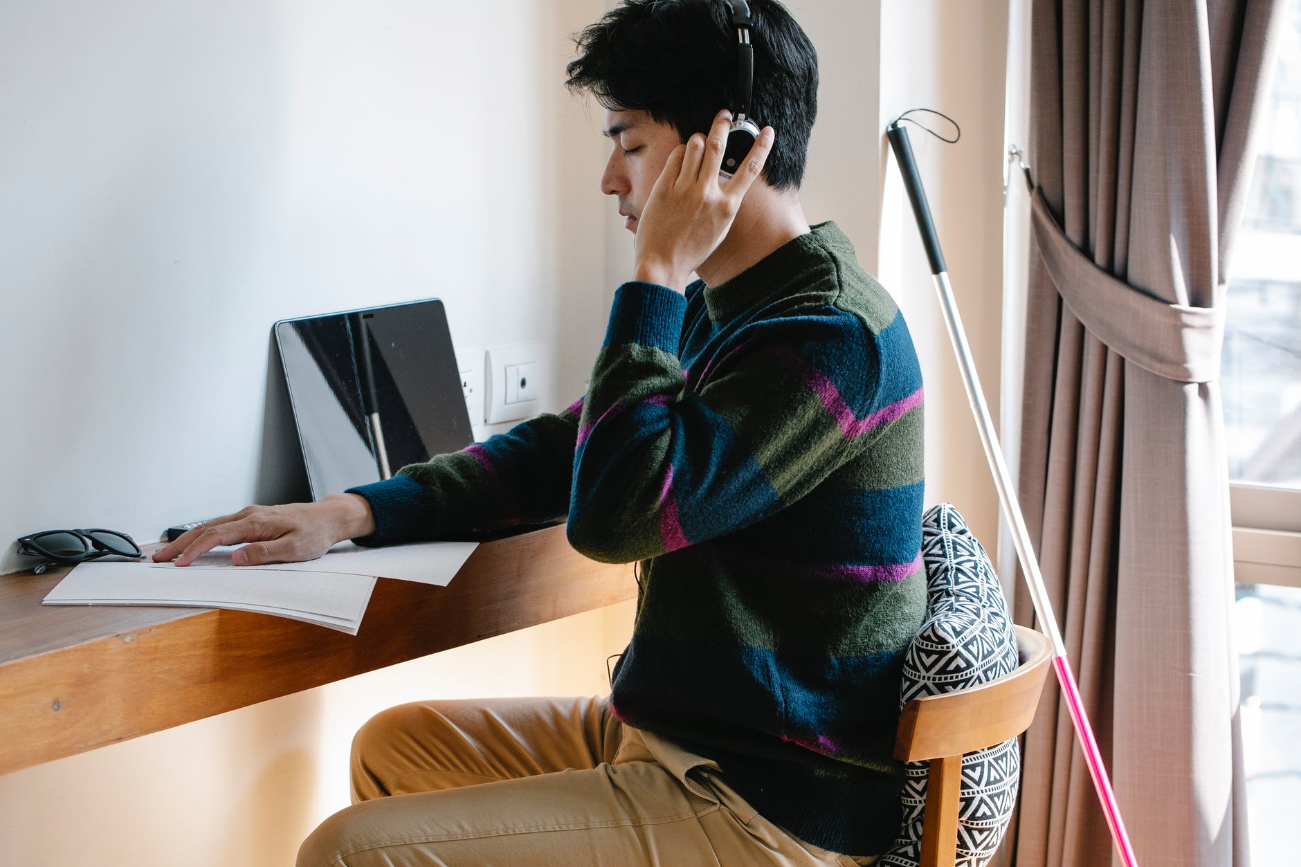 photo of man using headphones with deep concentration